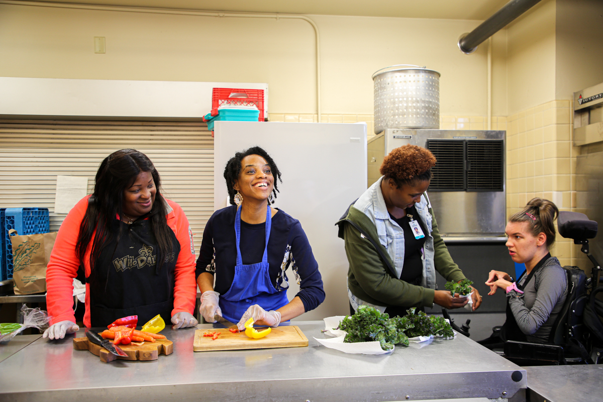 Guild members and employees cook in the kitchen